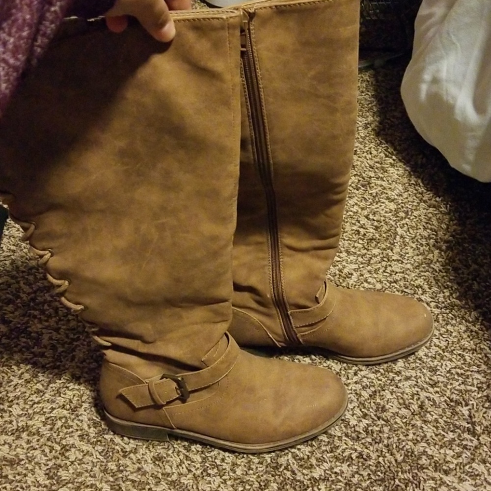 Tan boots with lace up detail in the back